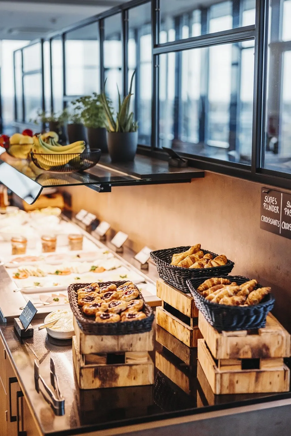 Breakfast buffet with fresh pastries and panoramic windows